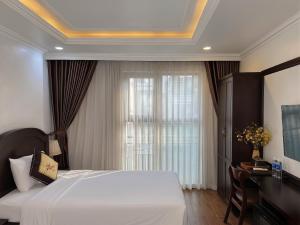 a bedroom with a white bed and a window at Mercy Hotel in Hanoi