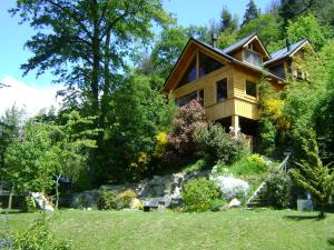 a house on a hill with a yard at El Recodo in San Martín de los Andes