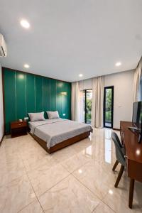 a bedroom with a large bed and a desk at Luxury villa Phu Quoc in Phú Quốc +22 photos