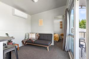 a living room with a couch and a window at Ngongotahā Getaway in Rotorua