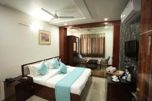 a hotel room with a bed and a television at Staykart Lotus in Bhilwara
