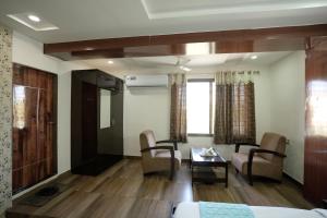a living room with a couch and a table at Staykart Lotus in Bhilwara