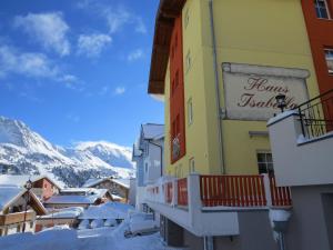 a building with a sign on it in the snow at Haus Isabella Obertauern in Obertauern