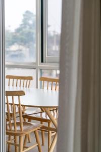 a table and chairs in a room with a window at Unplug Anguk in Seoul