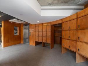 a large room with wooden lockers in a building at Unplug Anguk in Seoul