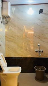 a bathroom with a yellow toilet and a sink at Odrine's abode - Udupi in Kalyānpur +40 photos