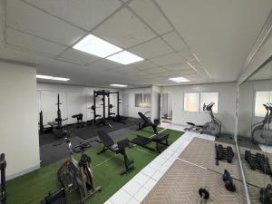 a gym with chairs and exercise equipment in a room at Forest View Leisure Residences in Olongapo