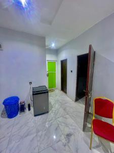a room with a green wall and a room with a chair at Ebest homes in Benin City