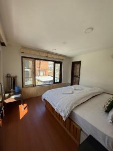 a bedroom with a large bed and a window at Mughal resort pahalgam in Pahalgām +3 photos
