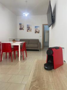 a living room with a couch and a table with a red suitcase at Supera Home in Gallipoli