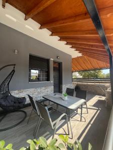an outdoor patio with a table and chairs at Grey Pearls Apartments in Nea Vrasna