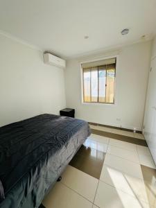 a bedroom with a bed and a window at Guest Room in Joan in St Albans