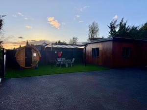 a backyard with a tent and a table and chairs at The Secret Lodge in Ashbourne