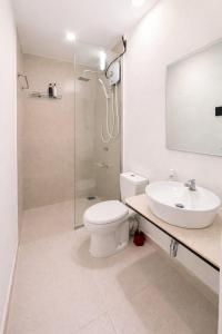 a bathroom with a toilet and a sink and a shower at Stara Weligama in Weligama