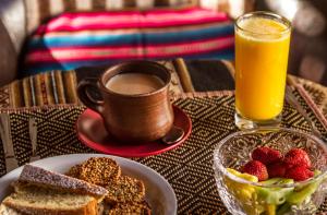 a table topped with a plate of food and a cup of coffee at Terrantai Lodge in San Pedro de Atacama