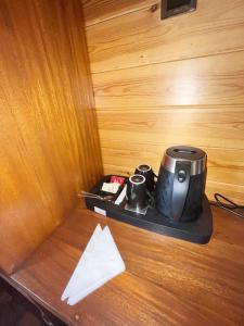 a coffee maker and two cups on a tray on a table at The Chill Heights Ramboda in Ramboda
