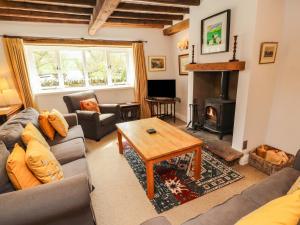 a living room with a couch and a fireplace at Two Town End in Penrith