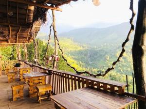 a balcony of a restaurant with tables and chairs at The Chill Heights Ramboda in Ramboda