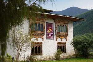 a house with a painting on the side of it at Samyae Resort in Jakar