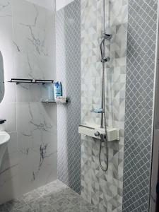 a bathroom with a shower with marble tiles at K won Villa in Busse