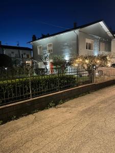 a house with lights in front of a fence at Parrot House in Bertinoro