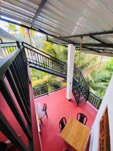 a balcony with a table and chairs and a mural at Sawmya Guest House in Randeniya +11 photos