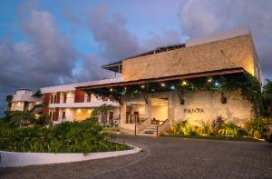 a building with lights on the side of it at Panja Resort Palawan in Puerto Princesa City