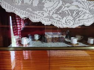 a display case with cups and dishes on a table at Milov konak in Berane