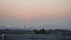 a sunset in the sky over a city at Vihari Foodway INN in Gooty