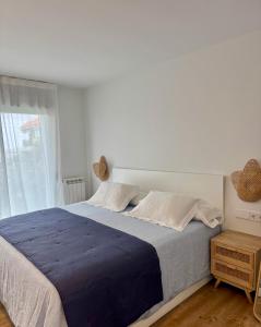 a white bedroom with a large bed and a window at Prado Essence in Sanxenxo +97 photos
