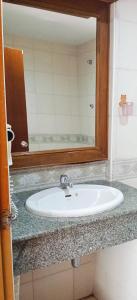 a bathroom with a sink and a mirror at Haweli Restaurant & Guest House in Ao Nang Beach