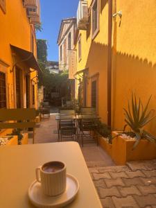 a cup of coffee sitting on top of a table at Hanole Macaron Guest House in Ayvalık +21 photos