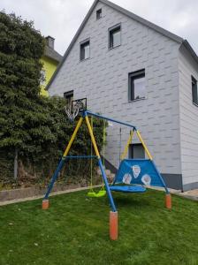 a playground with a basketball hoop in a yard at Haus Ella in Schwarzenbach am Wald