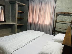 a bedroom with a white bed and a window at SRI Villa in Busse +3 photos