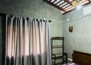 a room with a curtain and a wooden ladder at SRI Villa in Busse