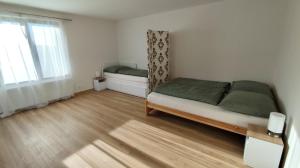 a small bedroom with a bed and a window at Apartmán Kozolupy in Kozolupy