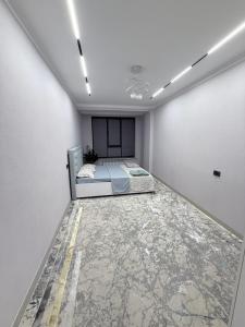 a white room with a bed in it at Frunze Residence in Osh
