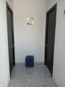 a hallway with two doors and a blue stool at Guest house Babaka in Sighnaghi +62 photos