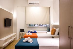 Säng eller sängar i ett rum på Injoy Lofts Ipanema