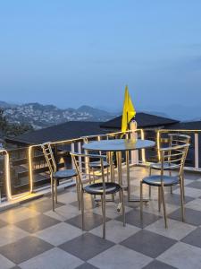 a table and chairs sitting on a roof at Sagar plaza in Mussoorie