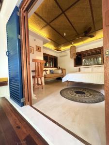 a bedroom with a bed and a table with a chair at Confluence Siargao in General Luna +60 photos