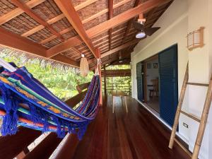 a hammock in the living room of a house at Confluence Siargao in General Luna