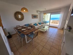 a living room with a table and a couch at ALBA MARINA Experience Peñiscola in Peniscola