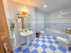 a blue and white bathroom with a sink and a toilet at ALBA MARINA Experience Peñiscola in Peniscola +34 photos