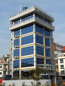 a tall building with a lot of windows at The Hotel Art 8 in Pātan