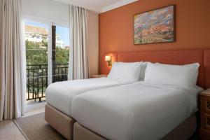 a hotel room with two beds and a window at Marriott's Marbella Beach Resort in Marbella +72 photos