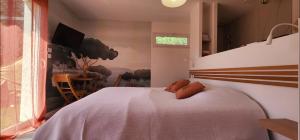 a bedroom with a large white bed and a table at Les Suites du XV in Cap d'Agde