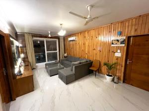 a living room with a couch and a chair at Mount kirola stay in Bhowāli