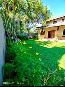 a yard with green grass and a house at Sithula Villa in Bentota +8 photos
