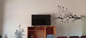 a flat screen tv sitting on top of a cabinet at Vachellia View in Marloth Park